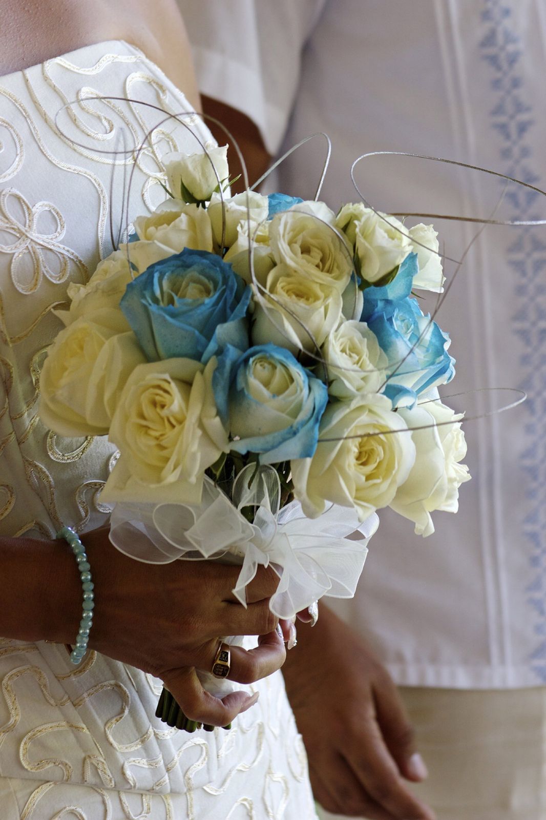 Ramo de rosas blancas y azules en las manos de la novia